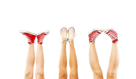 Students feet concept with sneakers on white background with space for textの写真素材