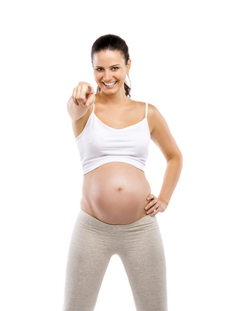 Studio portrait of a beautiful young pregnant woman ready for exercising, isolated on white backgroundの写真素材