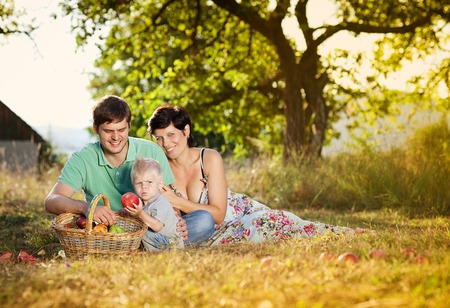 Happy and young family relaxing together in summer natureの写真素材