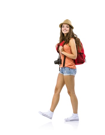 Young woman tourist with camera and backpack, isolated on whiteの写真素材