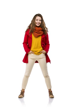 Beautiful girl in autumn clothes posing in studio, isolated on white backgroundの写真素材