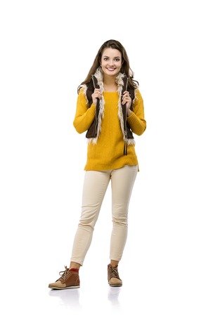 Beautiful girl in autumn clothes posing in studio, isolated on white backgroundの写真素材