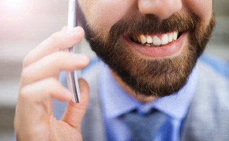 Detail of handsome hipster modern businessman using smart phone in the cityの写真素材