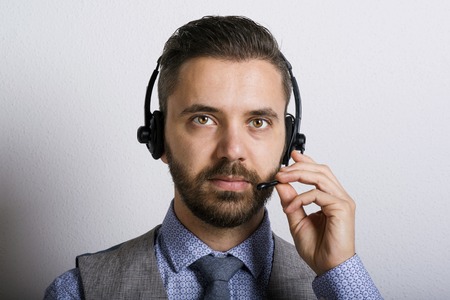 Call center operator isolated on white. Young handsome hipster man with headset.