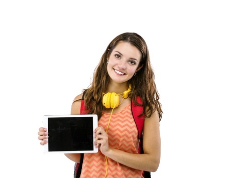 Beautiful young student girl with bag and digital tablet, isolated on white backgroundの写真素材