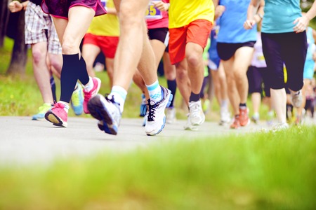 Group of unidentified marathon racers running, detail on legsの写真素材