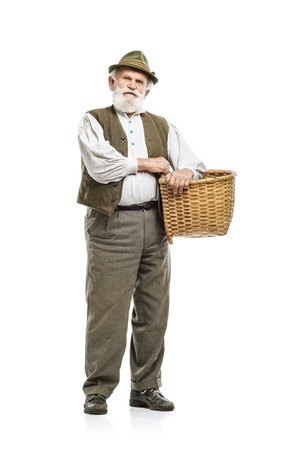 Old bearded farmer man in hat holding basket, isolated on white backgroundの写真素材