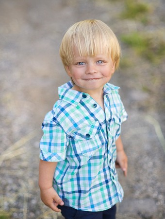 Portrait of blonde little boy posing outsideの写真素材