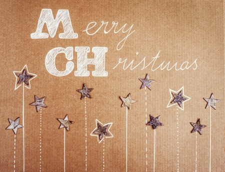 Christmas card with stars on cardboard backgroundの写真素材