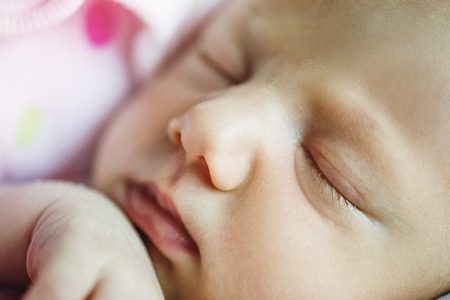 Cute sleeping baby on the bed indoors