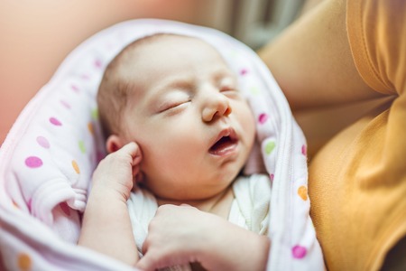 Cute sleeping baby on the bed indoorsの写真素材