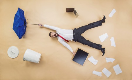 Handsome manager has an accident. Funny pose in studio.の写真素材