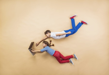 Funny children are playing together. Lying on the floor.