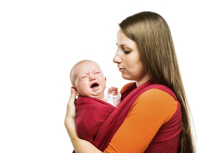 Crying child with mother isolated on white background in studioの写真素材