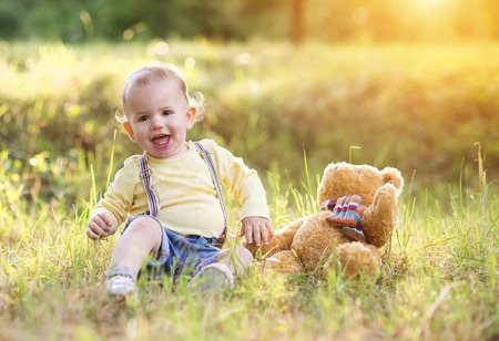 Little boy playing and having fun outside in a parkの写真素材