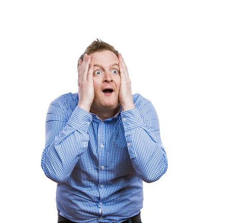 Funny young adult showing his emotions expressively by his gestures and mimics . Studio shot on...