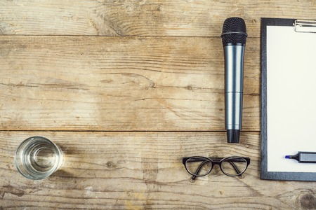 Composition of office gadgets and supplies on a wooden desk background. View from above.の写真素材