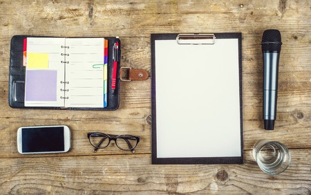 Composition of office gadgets and supplies on a wooden desk background. View from above.の写真素材