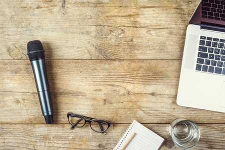 Composition of office gadgets and supplies on a wooden desk background. View from above.の写真素材