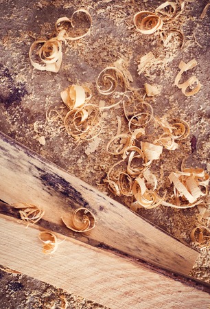Wooden planks and shavings at carpenters workshop