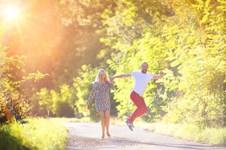 Attractive happy young couple having fun outside in a parkの写真素材