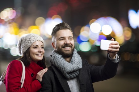 Trendy young hipster couple enjoying nightlife in the cityの写真素材