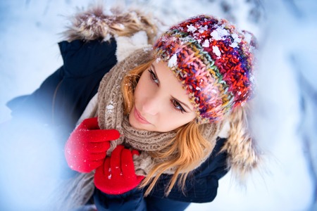 Beautiful young woman having fun outside in winter