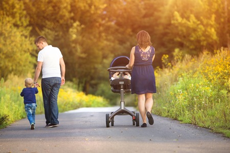Happy family on a walk in nature enjoying life together.の写真素材