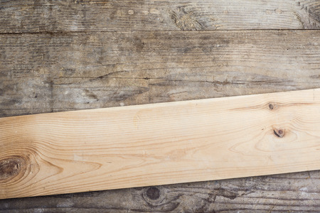 Board with texture laid on wooden floor backgroundの写真素材