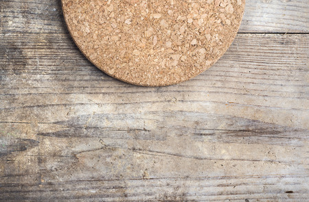 Round cork mat on wooden floor backgroundの写真素材