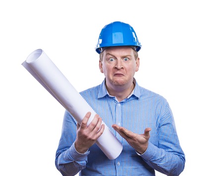 Engineer in blue hard hat holding a blueprint. Studio shot on white background.の写真素材
