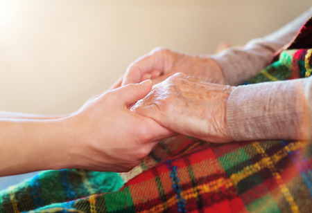 Unrecognizable grandmother and her granddaughter holding hands.の写真素材