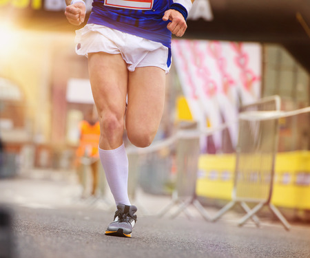 Unrecognizable young runner at the city competition