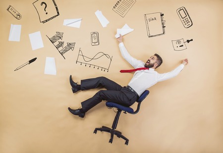 Handsome manager has an accident. Funny pose in studio.の写真素材