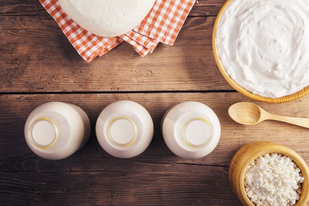 Variety of dairy products laid on a wooden table backgroundの写真素材