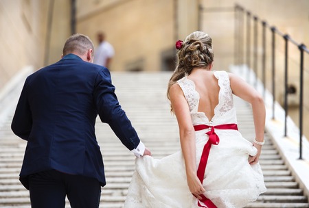 Beautiful wedding couple outside the castle on the stairsの写真素材