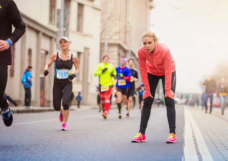 Young runner in the city race restingの写真素材