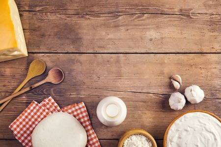 Variety of dairy products laid on a wooden table backgroundの写真素材