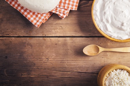 Variety of dairy products laid on a wooden table backgroundの写真素材