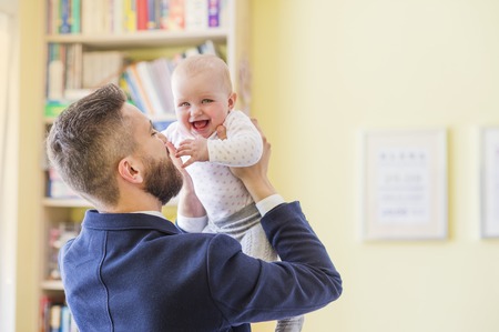 Young father with his cute little baby daughterの写真素材