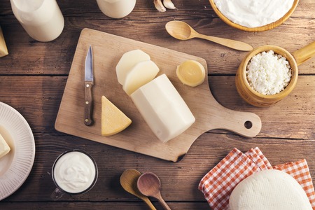 Variety of dairy products laid on a wooden table backgroundの写真素材
