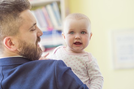 Young father with his cute little baby daughterの写真素材