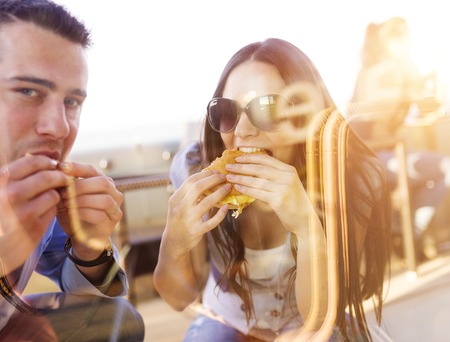Beautiful young couple enjoying a meal togetherの写真素材