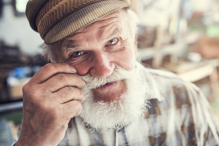 Closeup of a senior craftsman in his workshopの写真素材