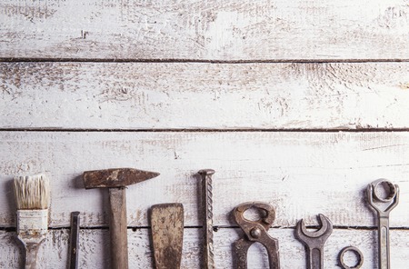 Desk of a carpenter with various tools. Studio shot on a wooden .の写真素材