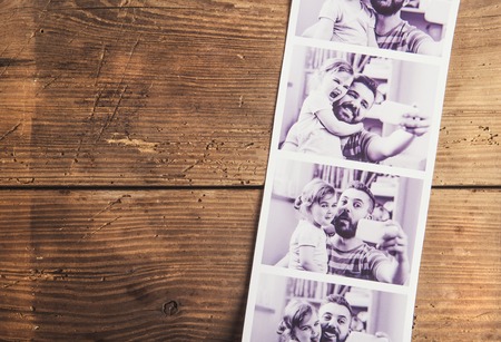 Black and white pictures of father and daughter laid on wooden floor backround.の写真素材