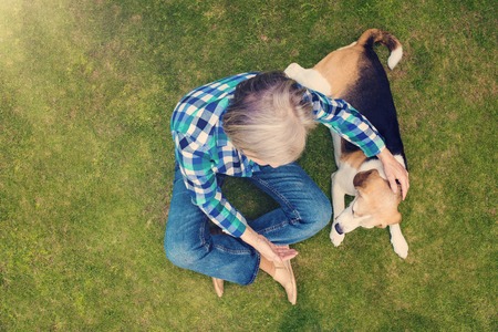 Beautiful senior woman lying on a grass in a parkの写真素材