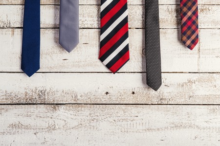 Fathers day composition of various ties hang on wooden wall background.の写真素材