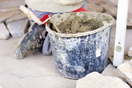 Mason putting decorative natural stones on a wall
