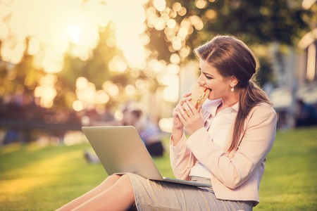 Attractive young business woman having a lunch breakの写真素材